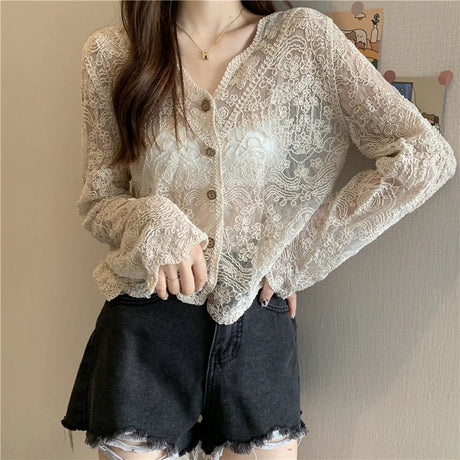 SheerCharm™ see-through lace sun shirt with long sleeves, sexy summer blouse for women, styled with black shorts.