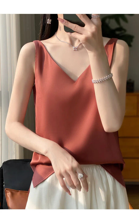 Model wearing a v-neck tank top in a warm hue, perfect for summer, showcasing elegant style and comfort.