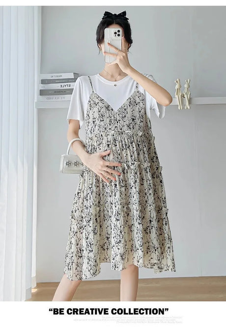 Elegant maternity dress featuring a floral design, perfect for summer and baby shower events, with a knee-length silhouette.