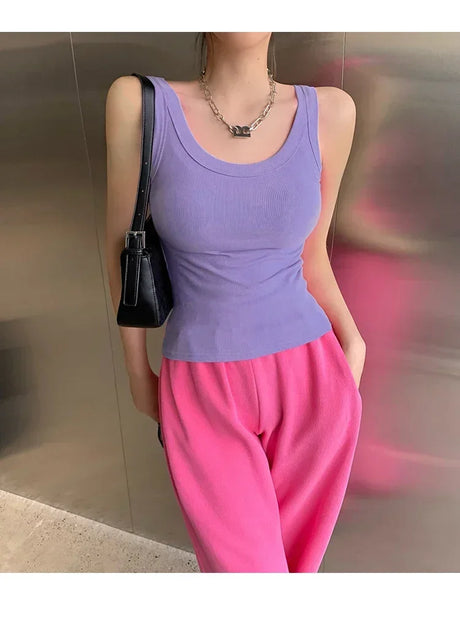 Model wearing a purple ribbed tank top with pink sweatpants, showcasing 90s vintage streetwear style.