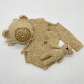 Newborn photo romper with bear bonnet and matching toy set, ideal for unisex newborn photography props.