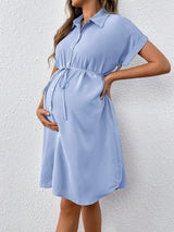 Light blue striped button maternity dress with short sleeves and tie waist, perfect for casual summer outings.
