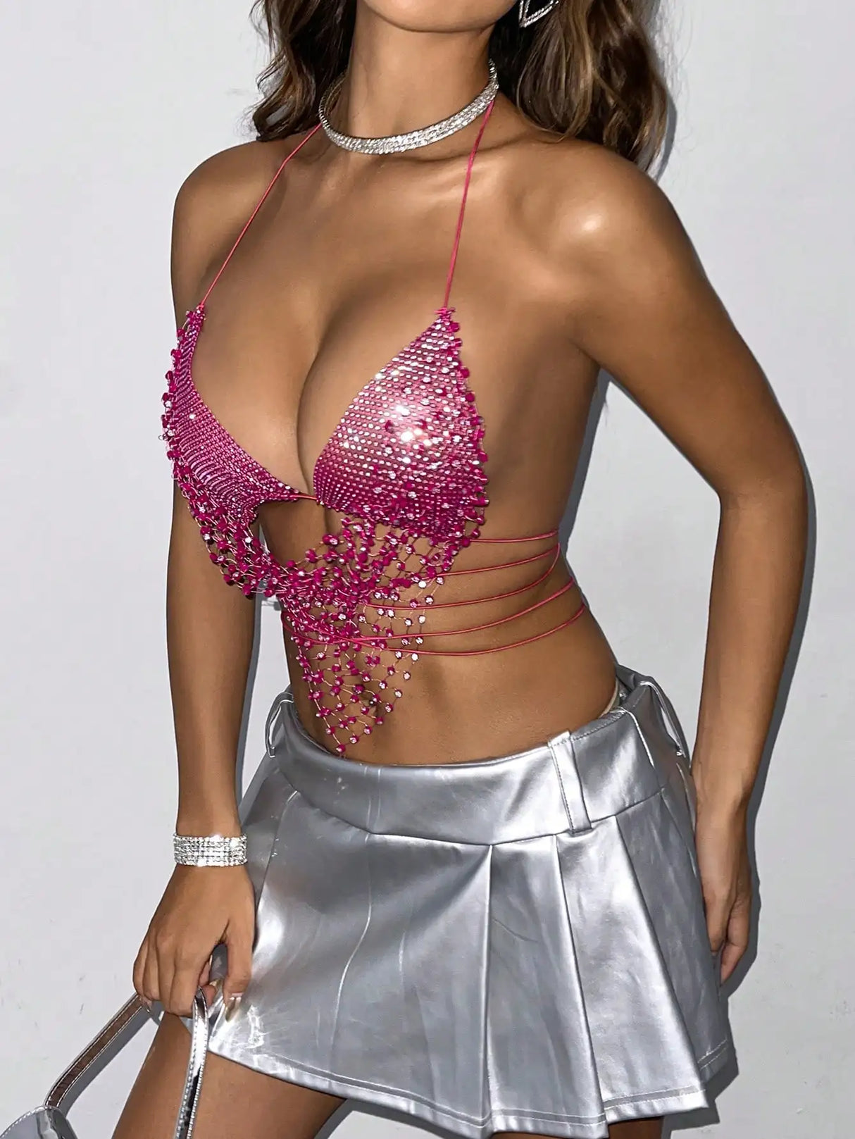 ShineLuxe™ backless rhinestone tank top with mesh details, paired with a silver pleated skirt for a glam party look.