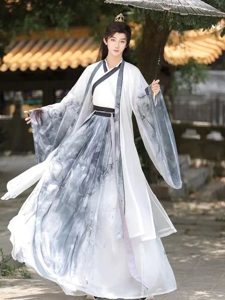 Men's traditional Chinese Hanfu with ink designs, featuring a cross collar and flowing sleeves in a serene outdoor setting.