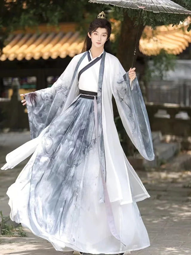 Men's traditional Chinese Hanfu with ink designs, featuring a cross collar and flowing sleeves in a serene outdoor setting.