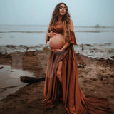 Pregnant woman in a Boho two-piece maternity set by the water, showcasing a natural look for a photoshoot.