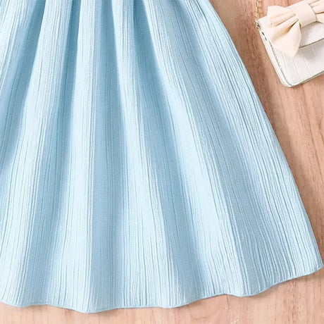 Light blue knee-length girls casual dress with textured fabric, perfect for summer outings.