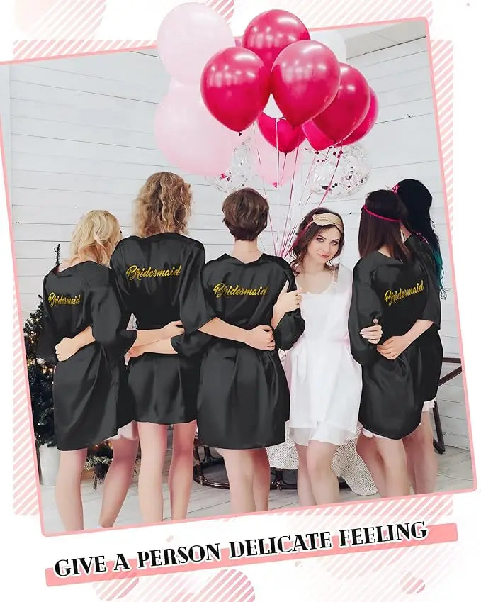 Group of bridesmaids wearing black satin kimonos, celebrating with balloons, showcasing the 10-Piece Bride Kimono Robe Set.