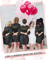 Group of bridesmaids wearing black satin kimonos, celebrating with balloons, showcasing the 10-Piece Bride Kimono Robe Set.