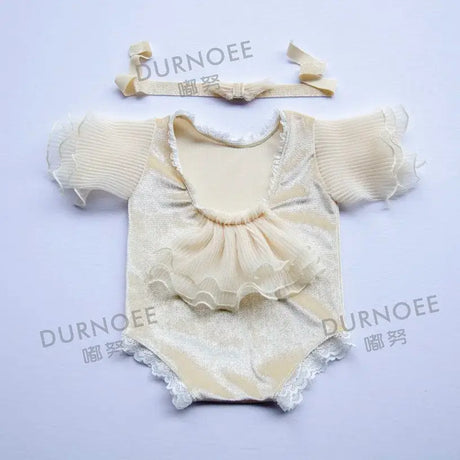 Newborn photography props featuring a soft, stylish beige romper with ruffles and matching headband, ideal for baby photoshoots.
