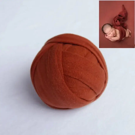 Solid rust-colored backdrop blanket for newborn photo shoots, made of soft polyester, ideal for unisex baby photography.
