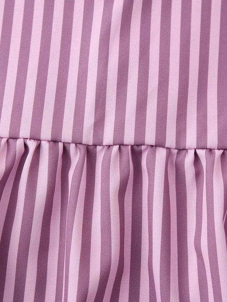 Close-up of a BowChic™ stripe lace-up blouse in soft purple hues featuring vertical stripes and gathered fabric.