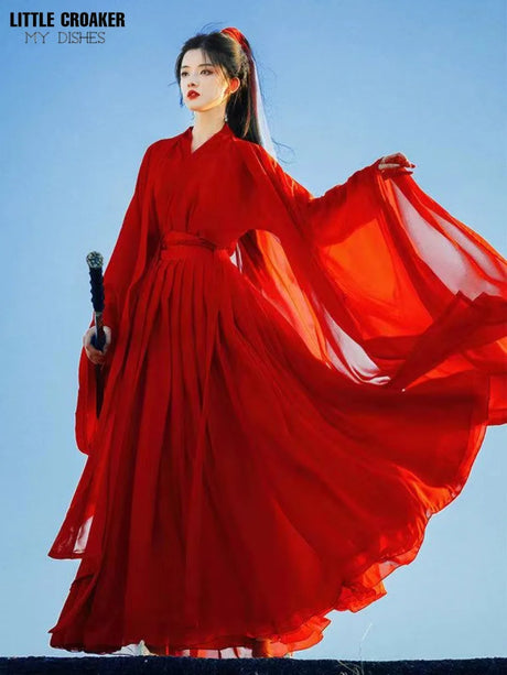Woman in elegant wine red Swordsman Hanfu costume, showcasing Tang Dynasty style with flowing sleeves.