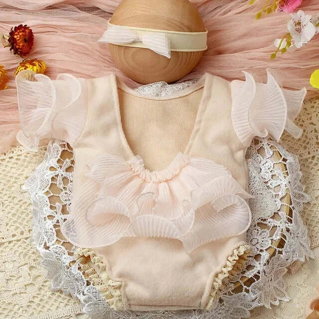 Newborn photography props set featuring a ruffled baby onesie in soft pastel colors, perfect for adorable photo sessions.