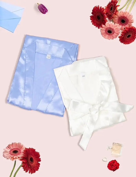 7-piece satin bride robe set in blue and white, perfect for bridesmaids and bridal parties, styled with flowers and accessories.