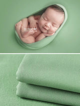 Newborn soft wrap blanket in soothing green color, perfect for photography and gentle comfort for babies.