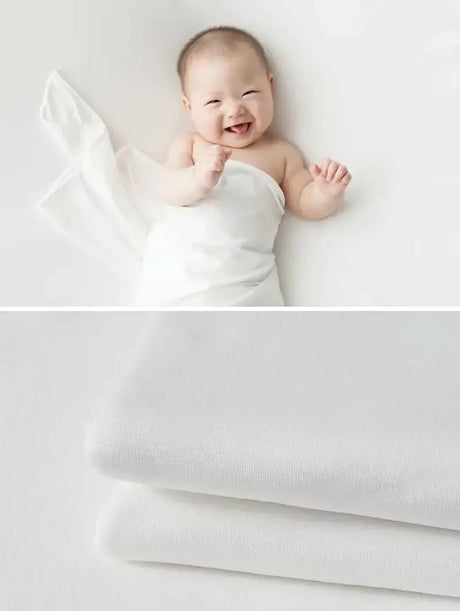 Newborn soft wrap blanket with a happy baby, perfect for photography and comfort, available in 55 colors.