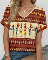 V-neck tee featuring vibrant African-inspired print with dancers and decorative patterns, perfect for casual wear.