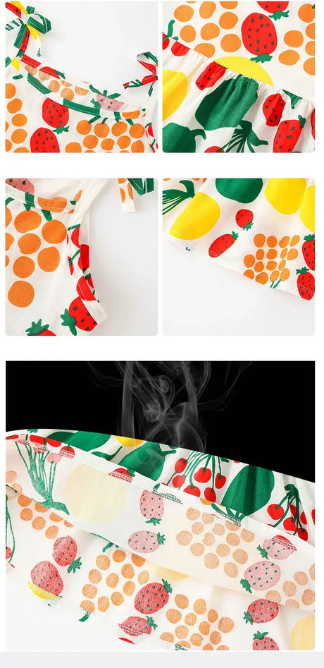 Close-up of cute summer girls dress featuring vibrant fruit prints including strawberries and lemons.