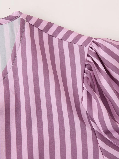 Close-up of striped lavender blouse showing puff sleeve detail and O-neck collar.