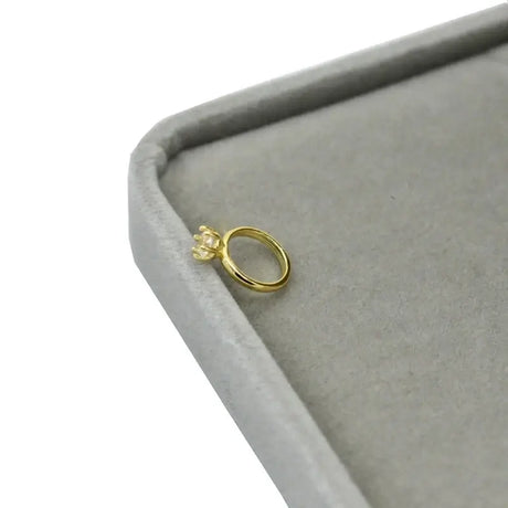 Exquisite newborn baby angel ring in gold, crafted for ages 0-6 months, displayed on a soft gray velvet box.
