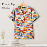 Colorful printed surgical scrub top in cotton, featuring a V-neck design, perfect for pediatric nursing uniforms.