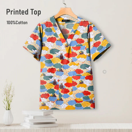 Colorful printed surgical scrub top in cotton, featuring a V-neck design, perfect for pediatric nursing uniforms.