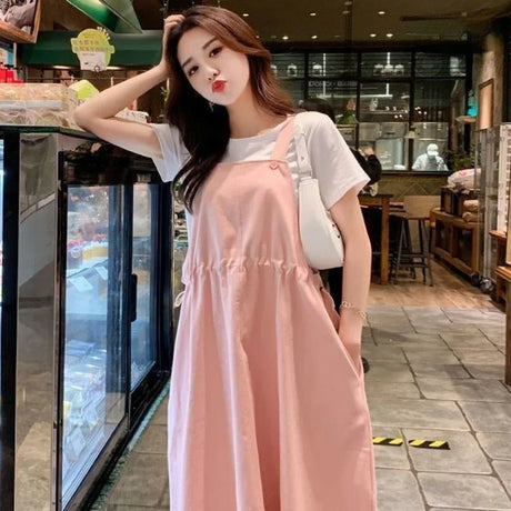 Korean loose fit maternity dress in pink, perfect for holiday photography and casual outings, worn by a young woman.