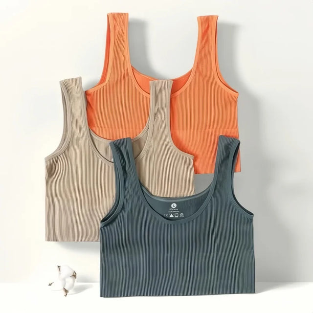 Four seamless ribbed camisoles in beige, orange, and dark gray, perfect for women's activewear and fitness.