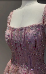 Close-up of fully crystal embellished mermaid wedding gown in soft pink hues with intricate beading and a square neckline.