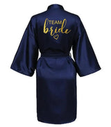 Navy satin robe with "TEAM BRIDE" gold lettering on the back, perfect for bridal party wear.
