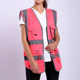 Hi-Vis pink safety vest with multiple pockets and reflective stripes for high visibility and durability in work environments.