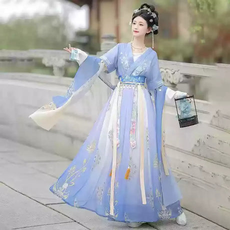 Elegant woman in a blue Hanfu traditional dress holding a lantern, showcasing a cultural party outfit.