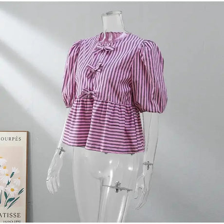 BowChic™ Stripe Lace-Up Blouse in purple and white stripes, featuring short puff sleeves and lace-up details.