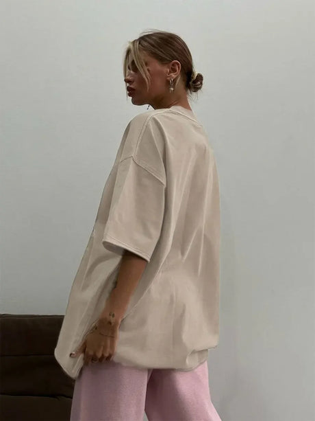 Model wearing a loose-fit beige casual t-shirt, showcasing relaxed style and comfort.