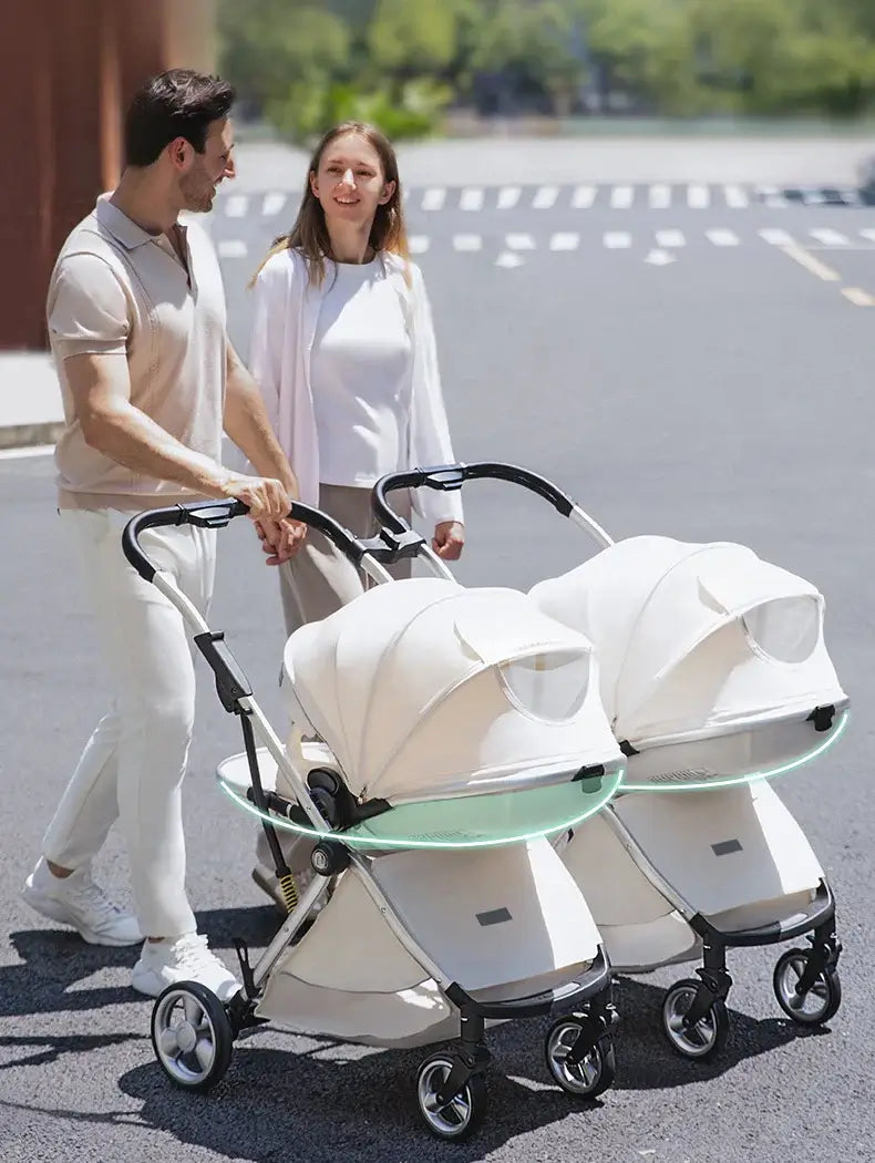 Couple walking with a twin baby stroller on a sunny day, featuring two comfortable seats and a sleek design.