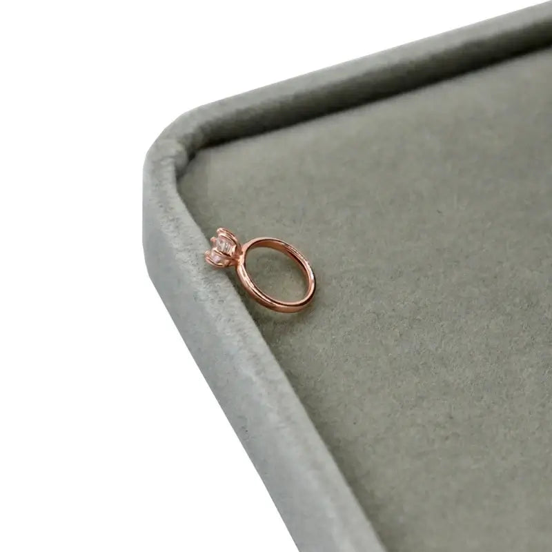 Exquisite newborn baby angel ring in rose gold, perfect for ages 0-6 months, displayed on a soft gray surface.