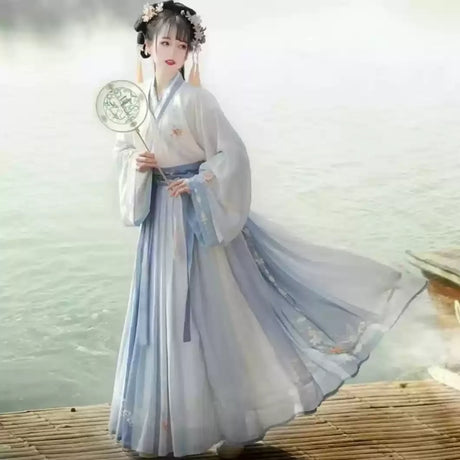 Woman in elegant Hanfu traditional dress, showcasing a flowing blue and white design, perfect for parties or cultural events.