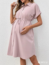 Striped button maternity dress in light pink with a casual summer style, featuring a turn-down collar and adjustable tie.