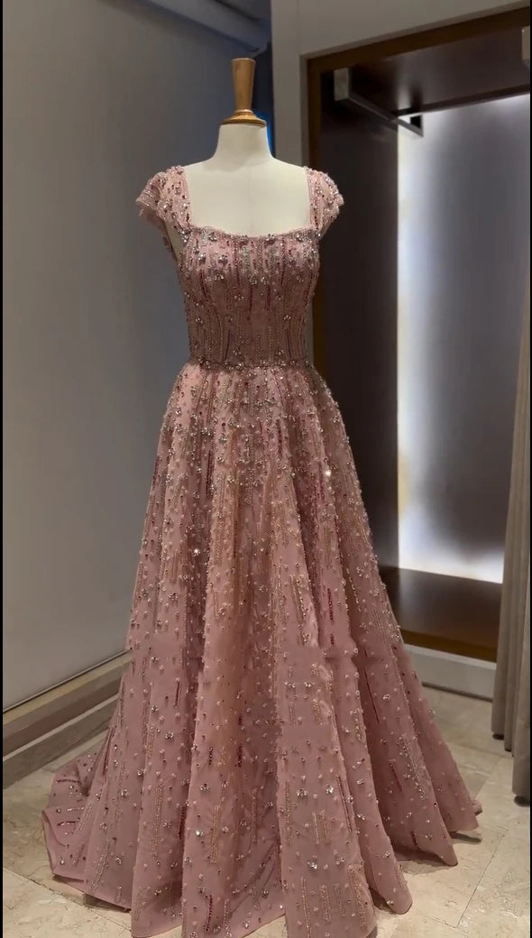 Glitter crystal mermaid wedding gown in pink with cap straps and beaded embellishments, showcasing luxury design.