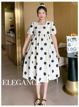 Polka dot loose maternity dress by YIGUDAR, white with black dots, mid-calf length, featuring short sleeves, perfect for summer.