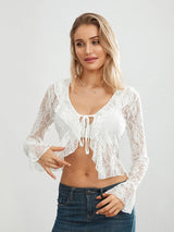 Model wearing TieGlam™ sheer lace crop cardigan with flare sleeves, styled in a casual look with jeans.