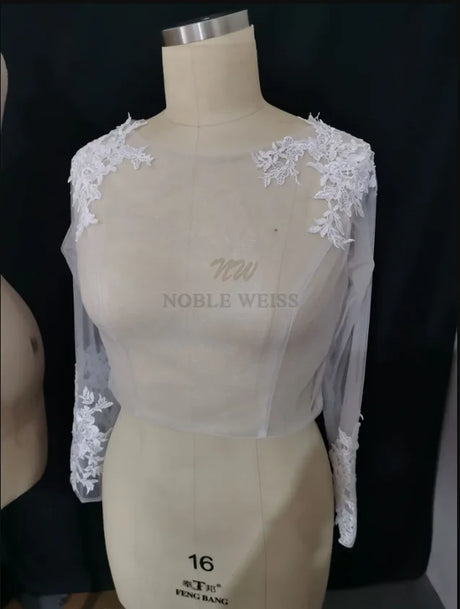 Lace Bridal Bolero with long sleeves and floral appliques for wedding outfits by Noble Weiss.