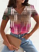 Women's vintage floral 3D print V-neck T-shirt in vibrant colors, paired with denim jeans and a styled handbag.