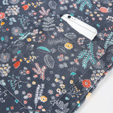 Navy blue nurse scrub with floral patterns and a pocket, ideal for medical professionals and beauty salons.