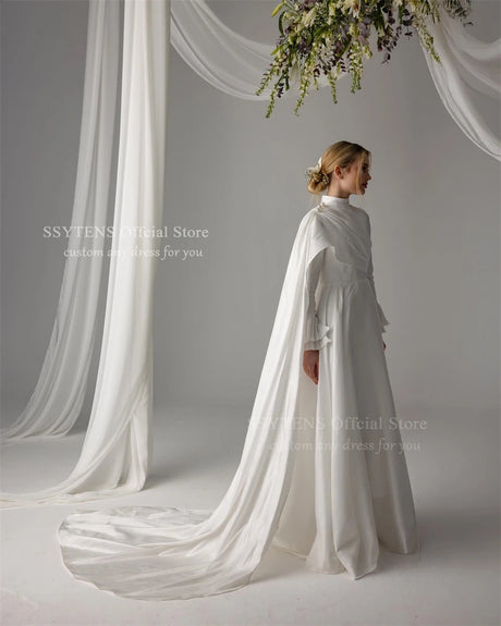 Elegant Muslim satin wedding dress with high neck, long sleeves, and trailing fabric, adorned with pearls.
