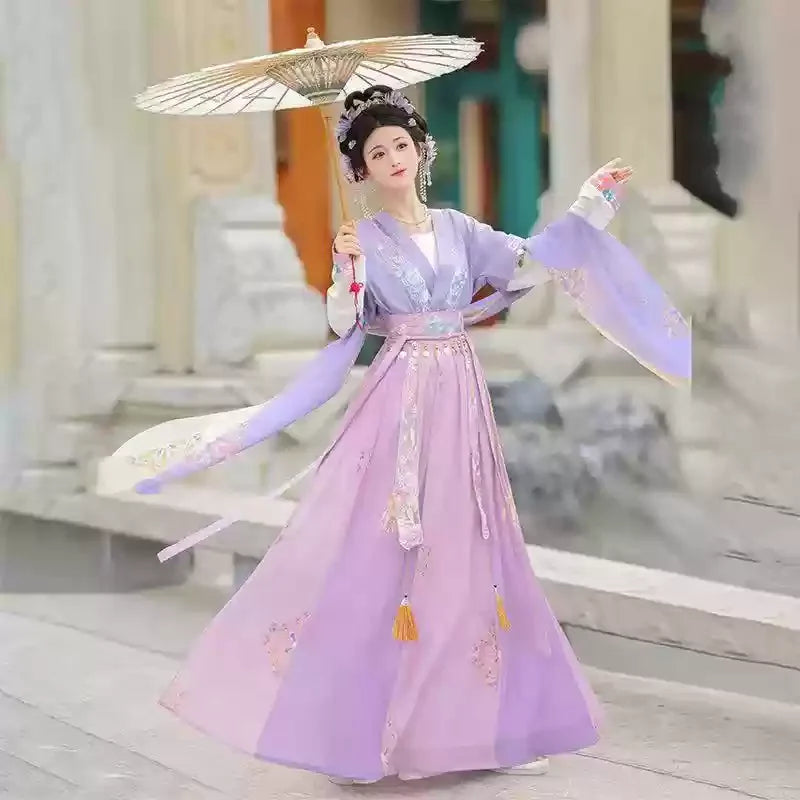 Elegant Hanfu traditional dress for women in soft purple, perfect as a party outfit, featuring detailed embroidery and a decorative umbrella.