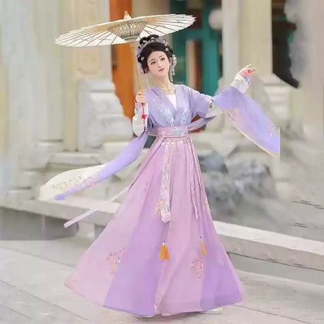 Elegant Hanfu traditional dress for women in soft purple, perfect as a party outfit, featuring detailed embroidery and a decorative umbrella.