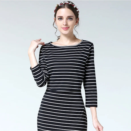 Postpartum nursing maternity dress in black and white stripes, featuring 3/4 sleeves and a boat neck design.