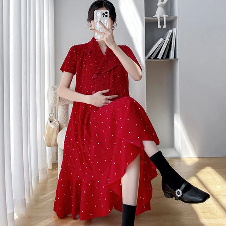Red polka dot maternity dress with short sleeves and mid-calf length, perfect for summer outfits.